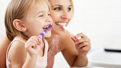 Person brushing teeth for oral health